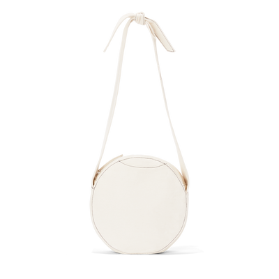 Dagne Dover Luna Shoulder Bag in white with the adjustable shoulder handle extended.