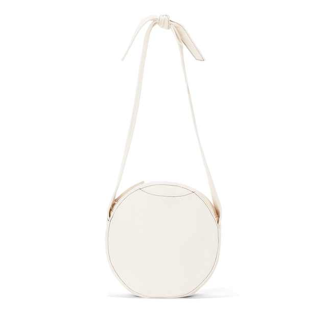 Dagne Dover Luna Shoulder Bag in white with the adjustable shoulder handle extended.