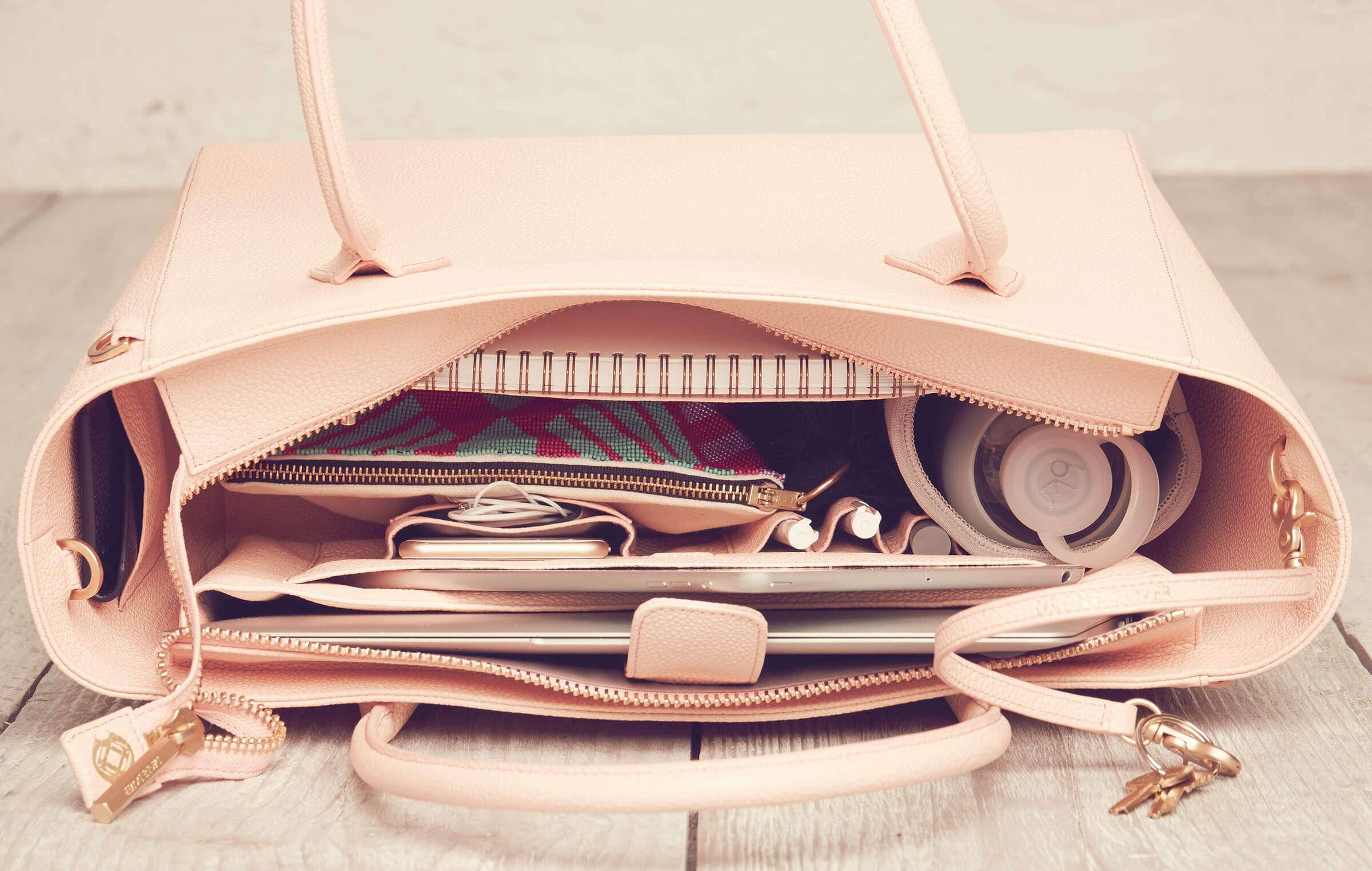 The Charlie Tote in Pale Peach $495, The Mini Tote in Fog Blue $245, The 15-Inch Tote in Pale Peach Stingray $365